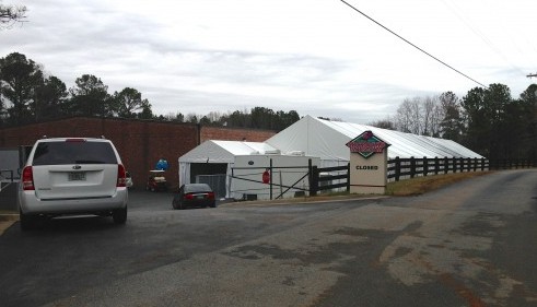 Its hard to take a pic of it, but this is the tent that covers the entire Museum Parking Lot. Right now there are a bunch of cars in it to make room for more people in the building. Later tonight (probably going on right now) MORE cars will be moved out of the building into the Tent to accommodate the roughly 1000 chairs that have to be set up for Registered Bidders. Will try and get you you some images of that in the morning.